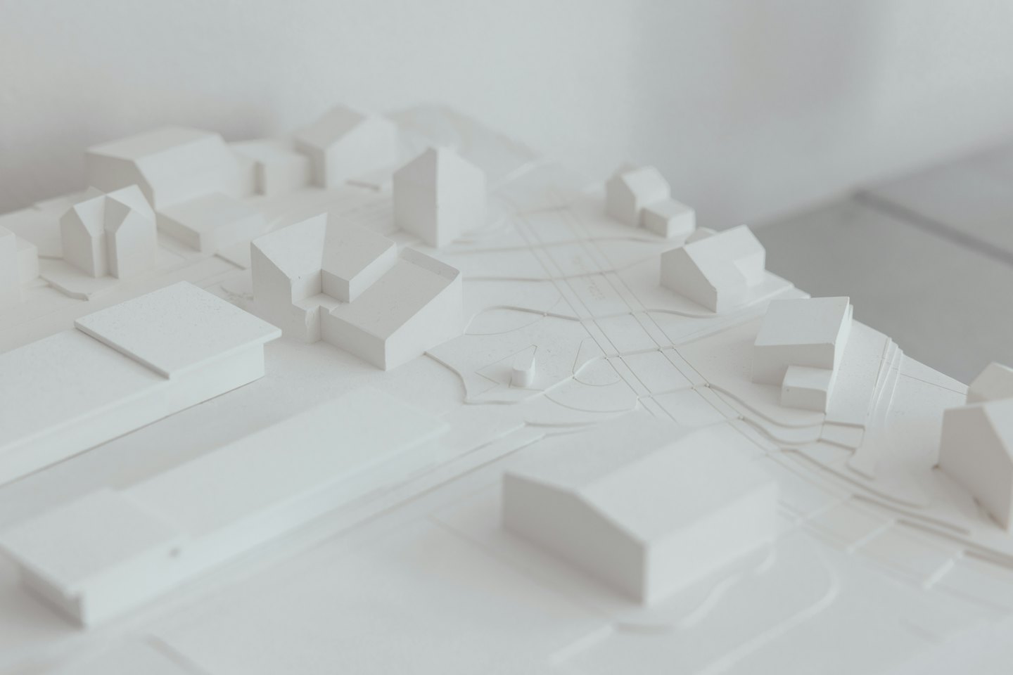 White architectural model of urban planning with buildings and roads.